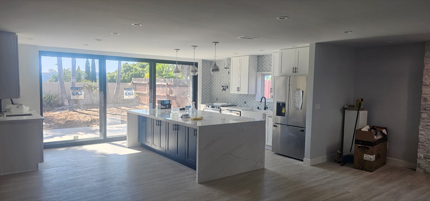 Modern open kitchen with marble island and blue cabinets
