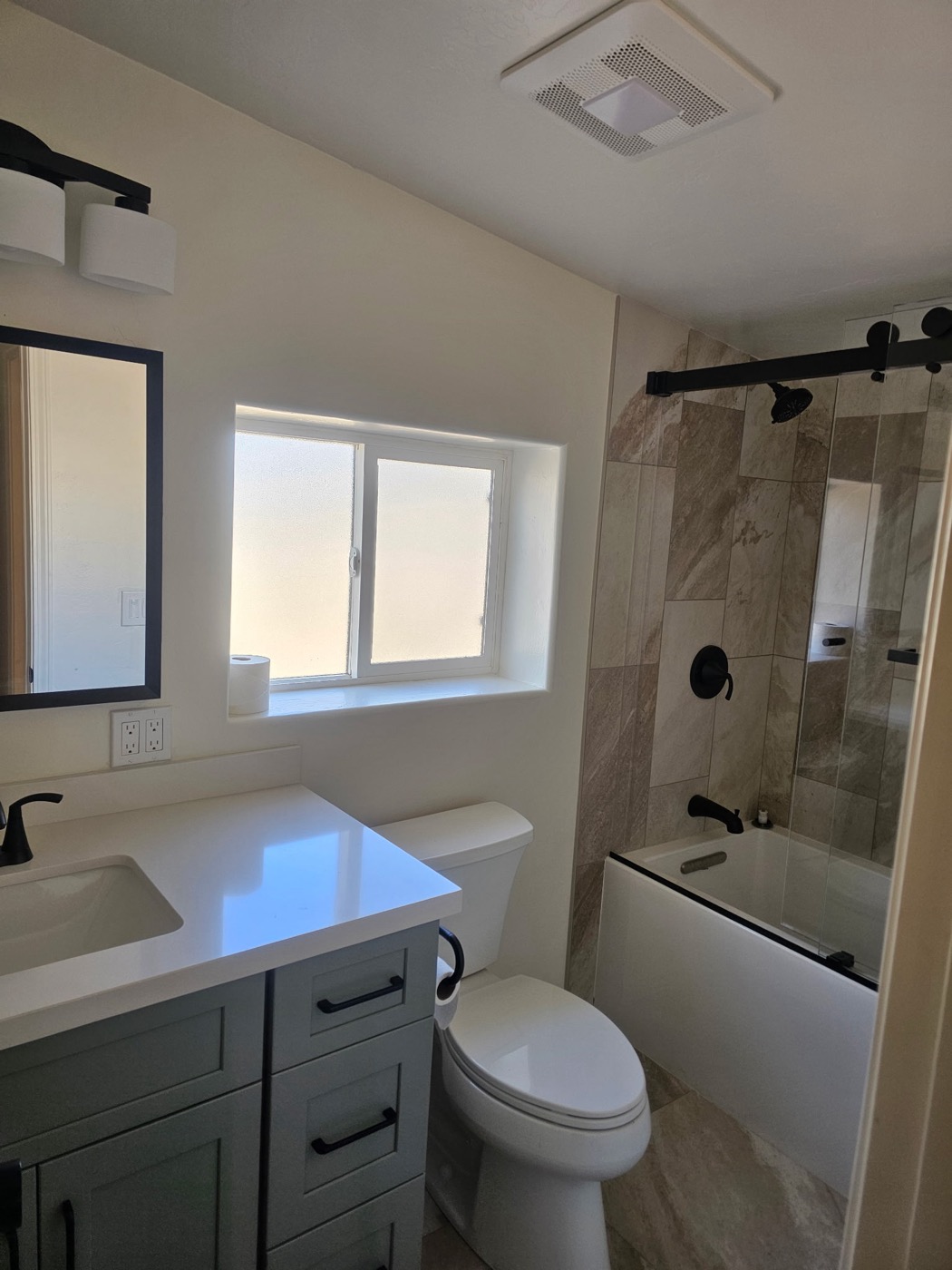 Bathroom remodel with stone tile and bathtub combo