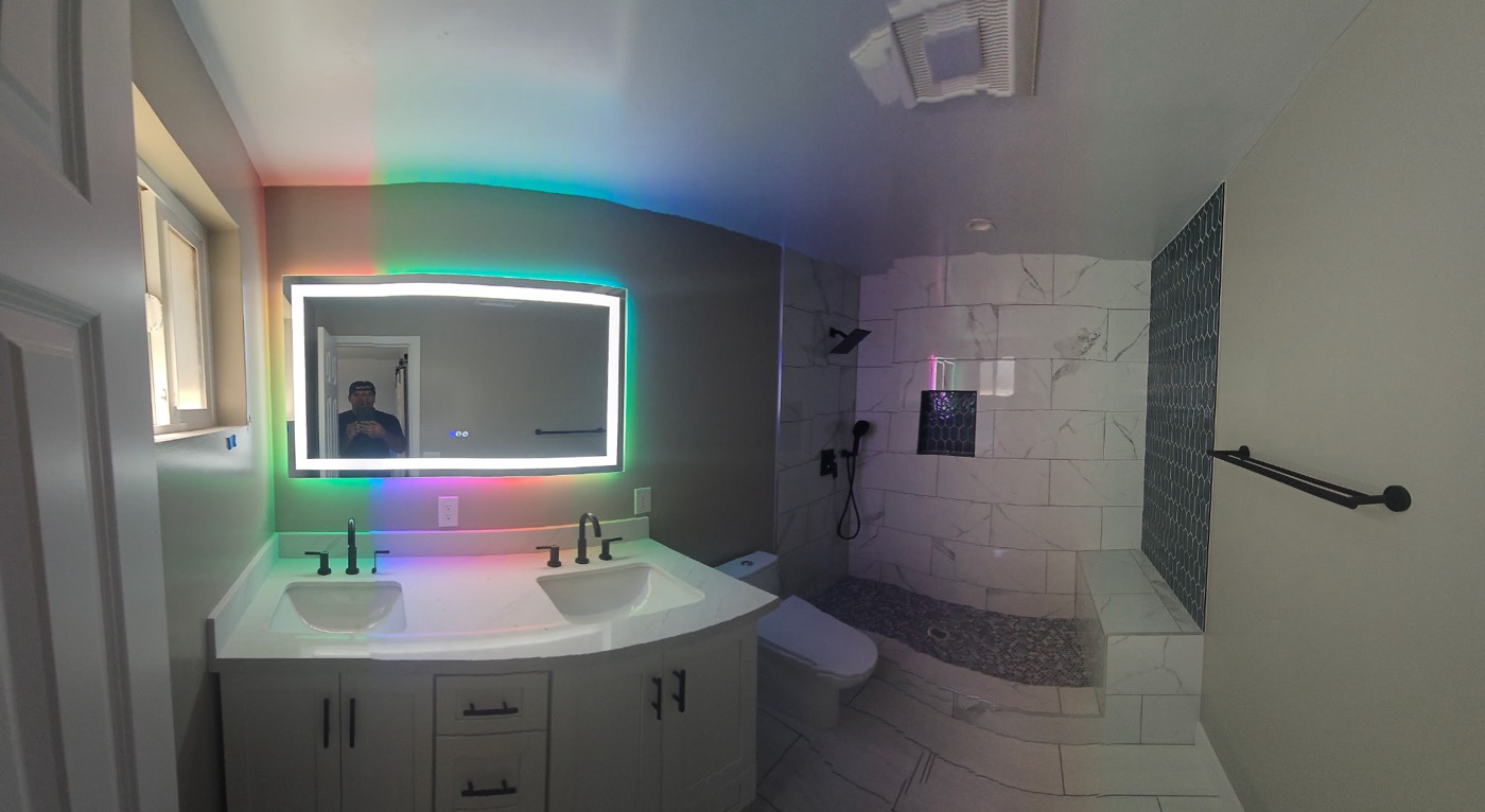 Master bathroom with LED backlit mirror and walk-in shower