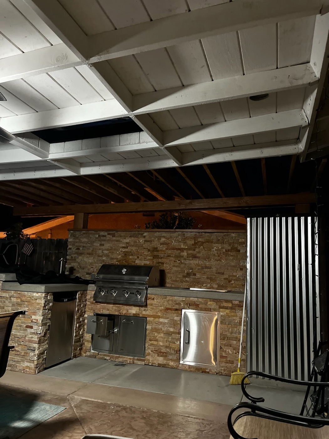 Covered outdoor kitchen with pergola and built-in BBQ