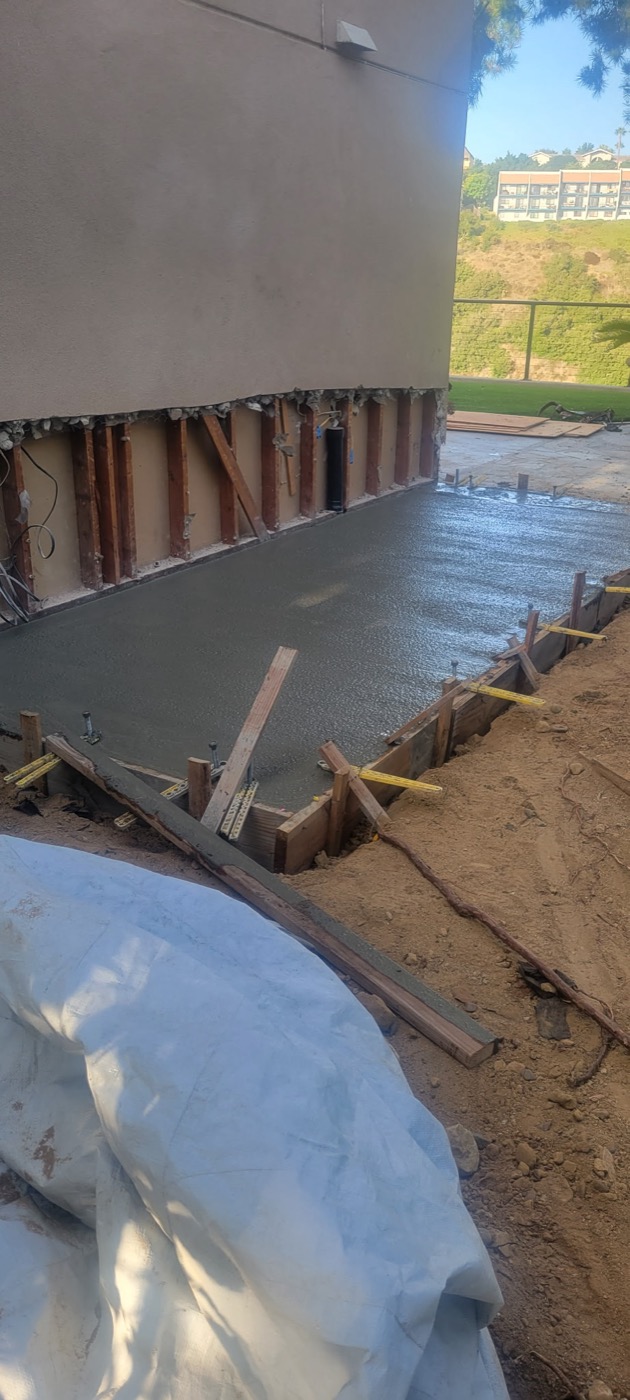 Fresh concrete slab foundation pour for new structure
