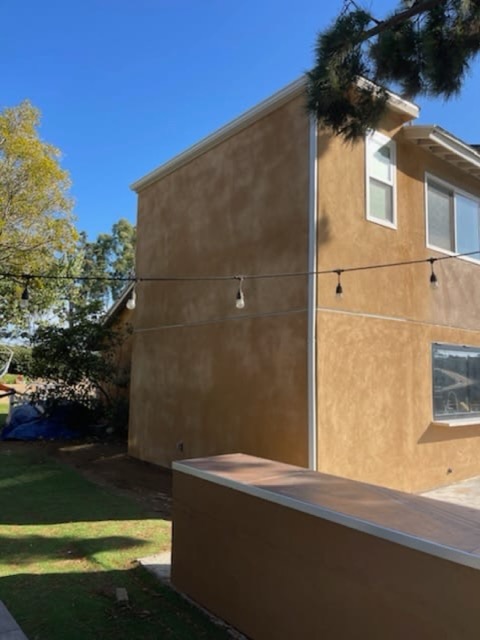 Completed ADU with warm stucco exterior and string lights