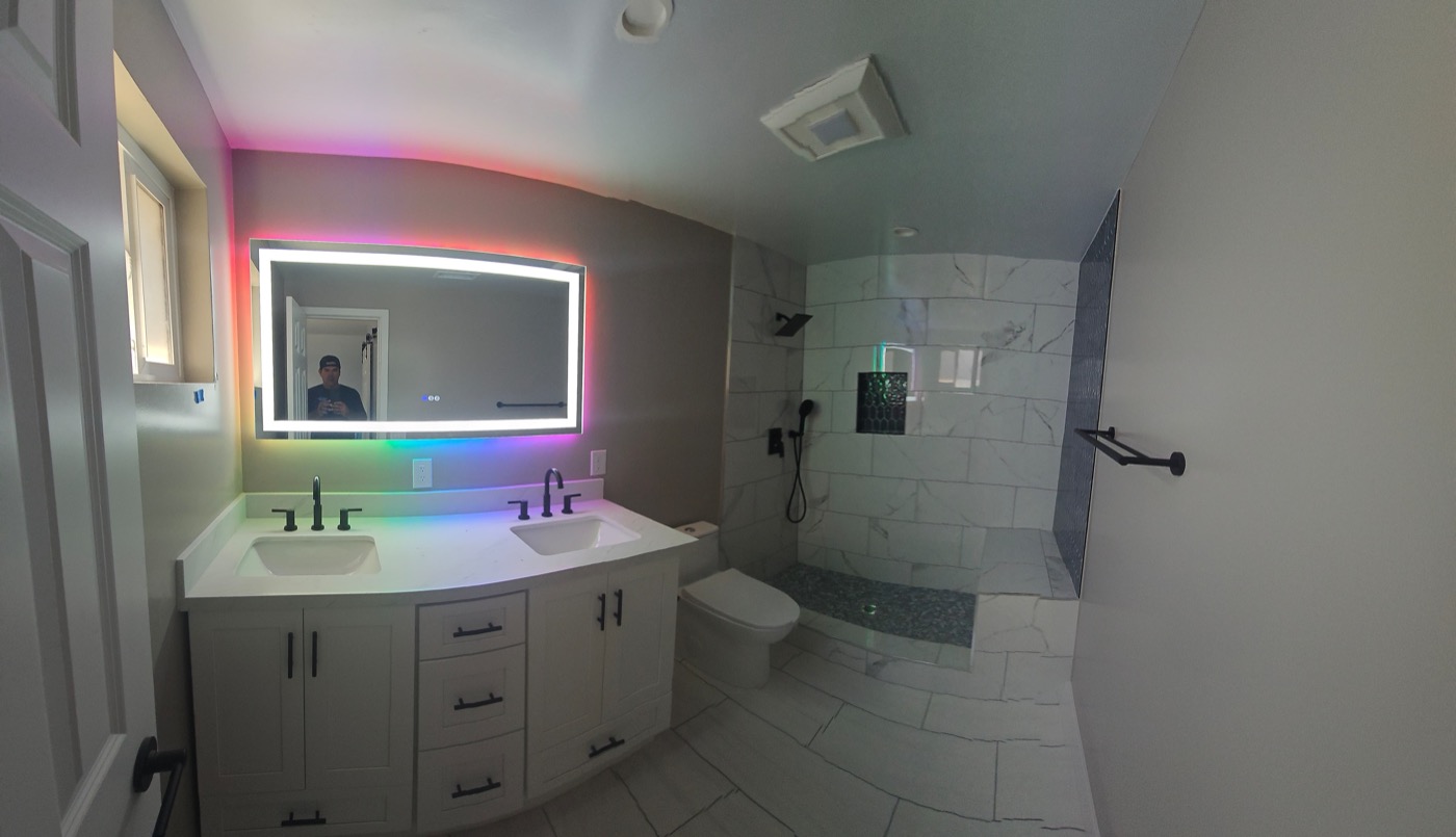 Master bathroom with LED backlit mirror and custom walk-in shower
