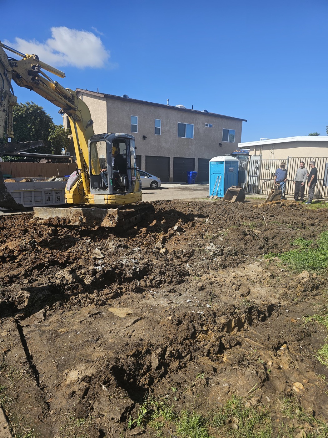 Excavator clearing site for new construction