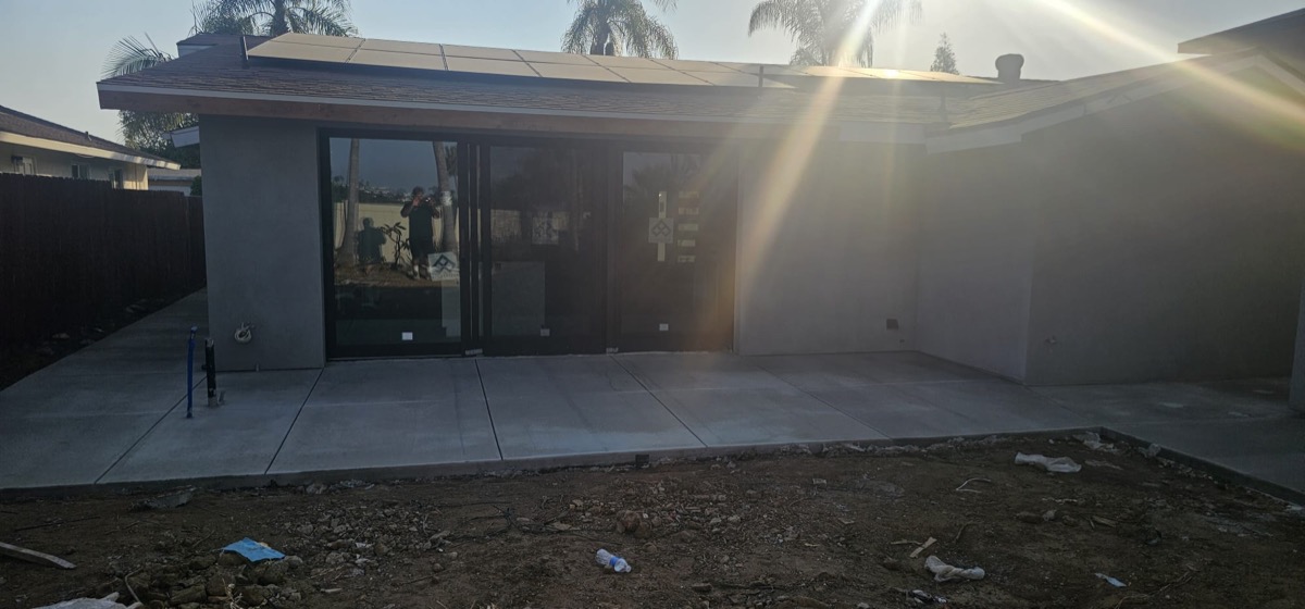 Completed modern ADU with solar panels and large sliding glass doors