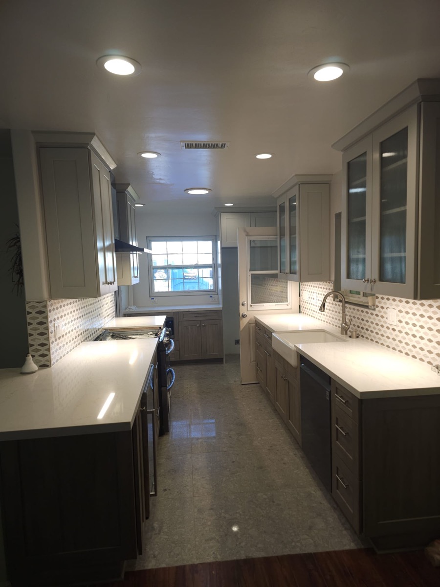 Galley kitchen with gray cabinets and under-cabinet LED lighting